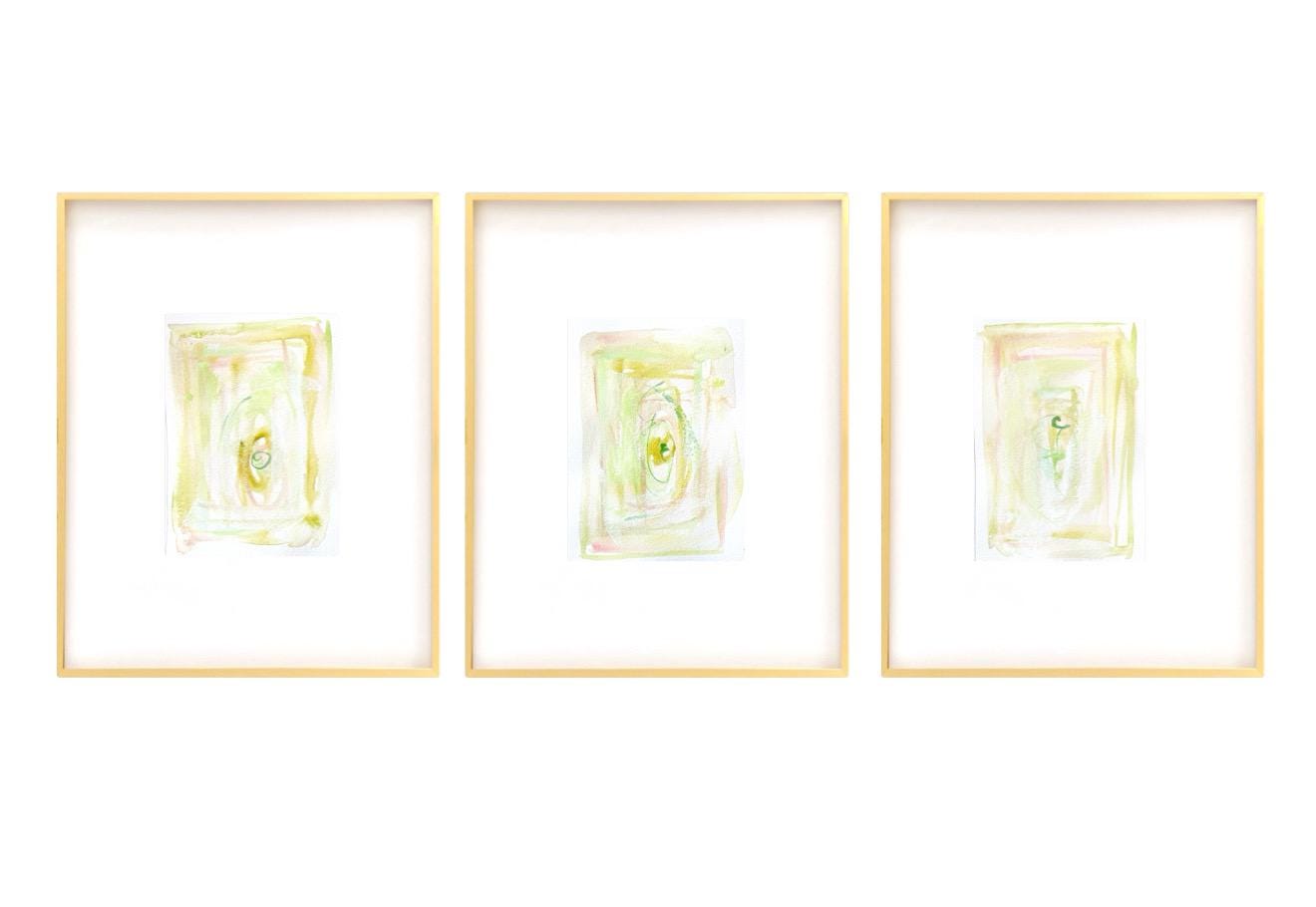 Set of 3 framed abstract watercolor paintings with light pastel colors in gold gallery frames
