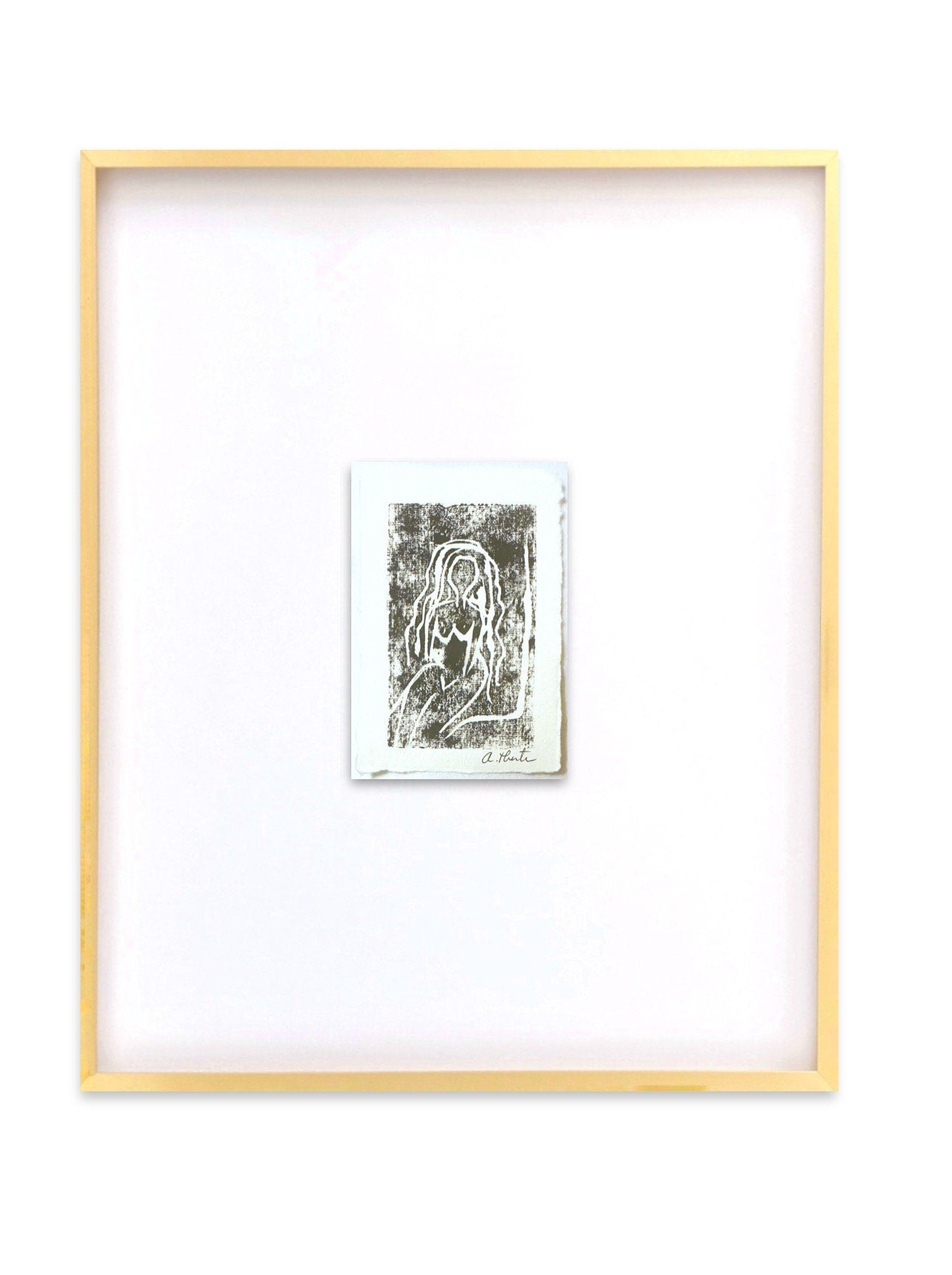 Framed artwork of abstract nude figure monoprint in gold metal gallery frame with white mat and glass