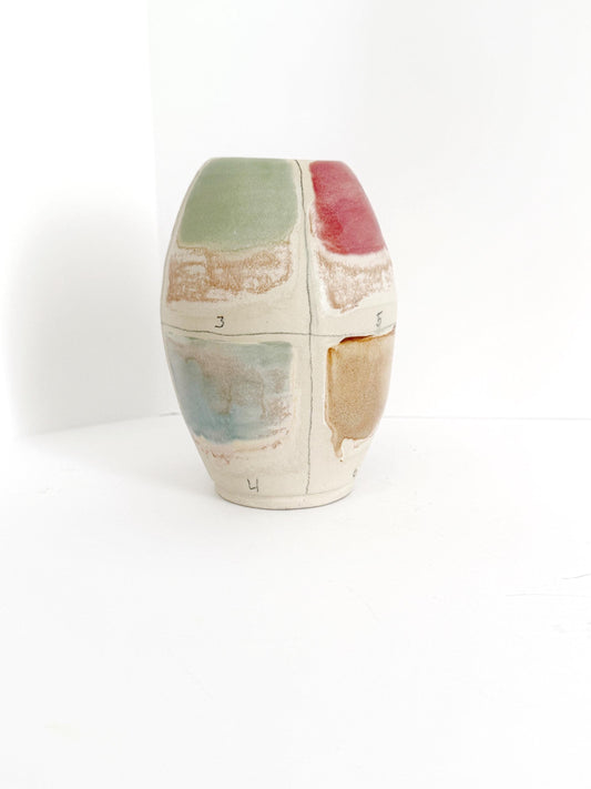 Handpainted clay multicolor vase with signature on bottom.