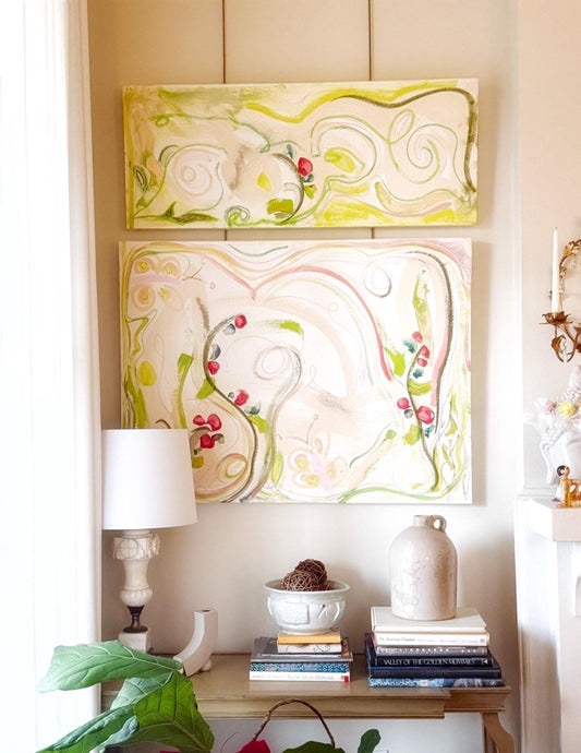 Original abstract mixed media painting Garden of Eden diptych with pink, green, and neutral tones on two canvases displayed above a wooden console table