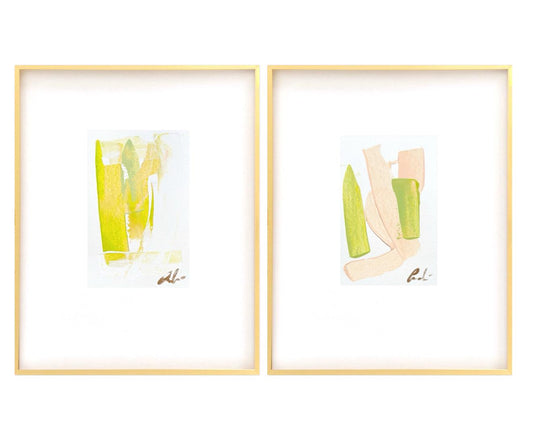 Pair of abstract watercolor paintings in pink and green hues, each 5x7 inches, matted white and framed in gold metal gallery frames.